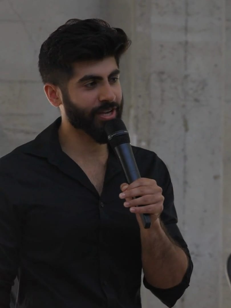 Rahul Dhiman speaking into a microphone while leading a Spiral Studios workshop.