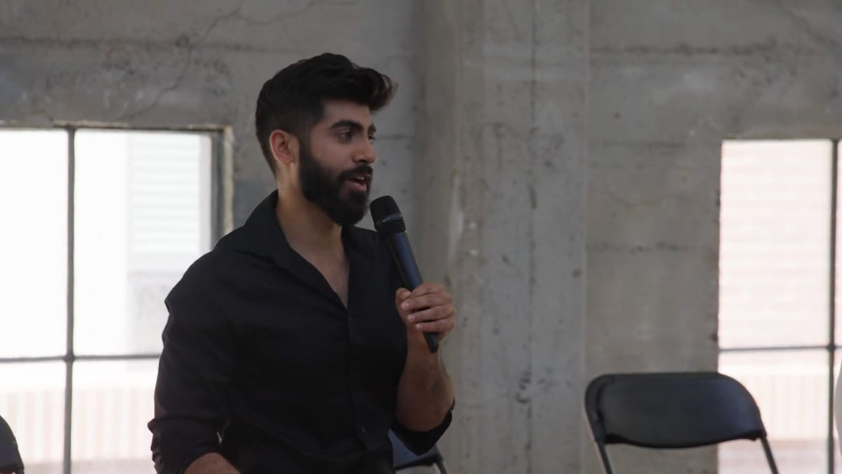 Rahul Dhiman speaking into a microphone while leading the workshop.